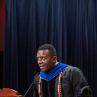 Male guest speaker stands at podium